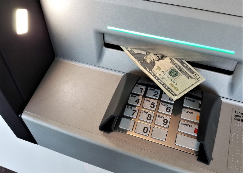 Cash Money Dollar Bills Withdrawn from ATM Automated Teller Machine