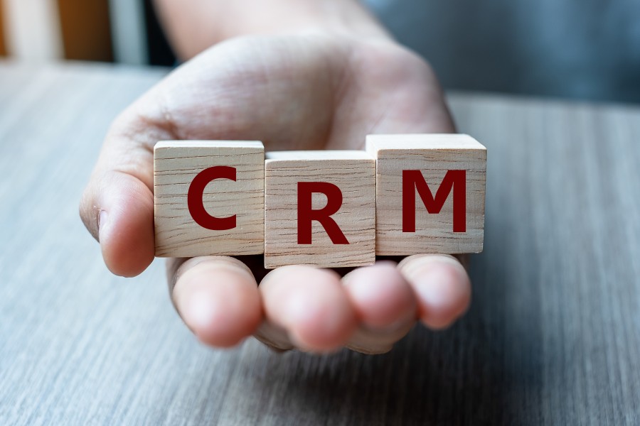 Hand Holding CRM Wooden Blocks Choosing Right Customer Relations Management Tool Software SaaS