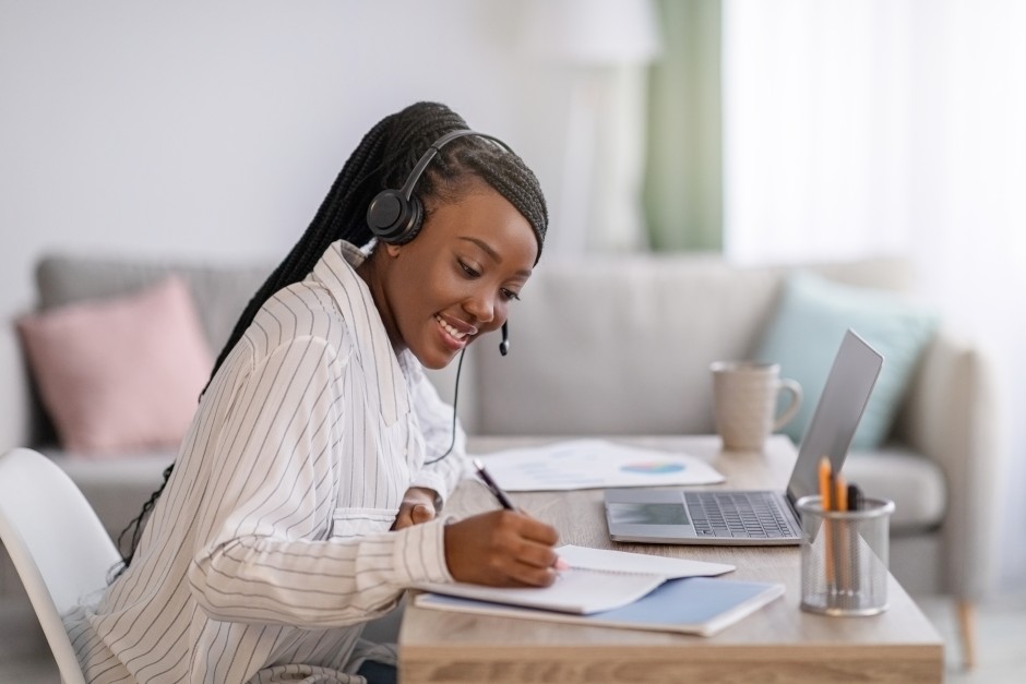 Happy Woman Female Attending Online Course Program Taking Notes