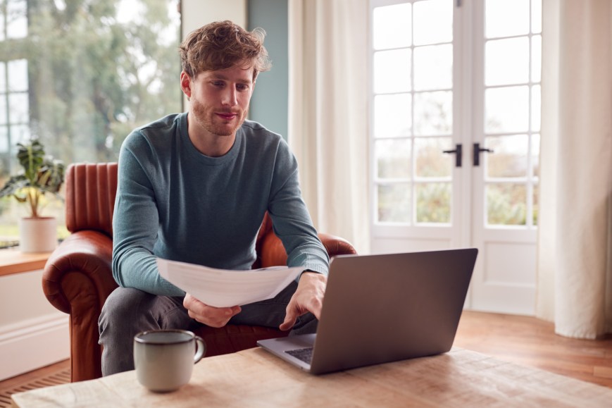 Man Sitting Chair Home Laptop Understanding Financial Needs Choose Right Loan