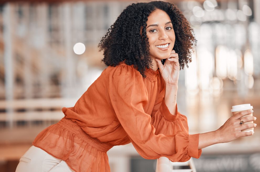 Portrait of a happy and confident woman holding a cup of coffee