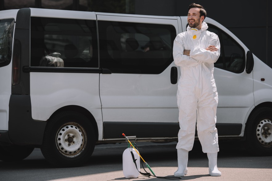 Smiling Happy Pest Control Worker Business Owner Standing In Front of Van