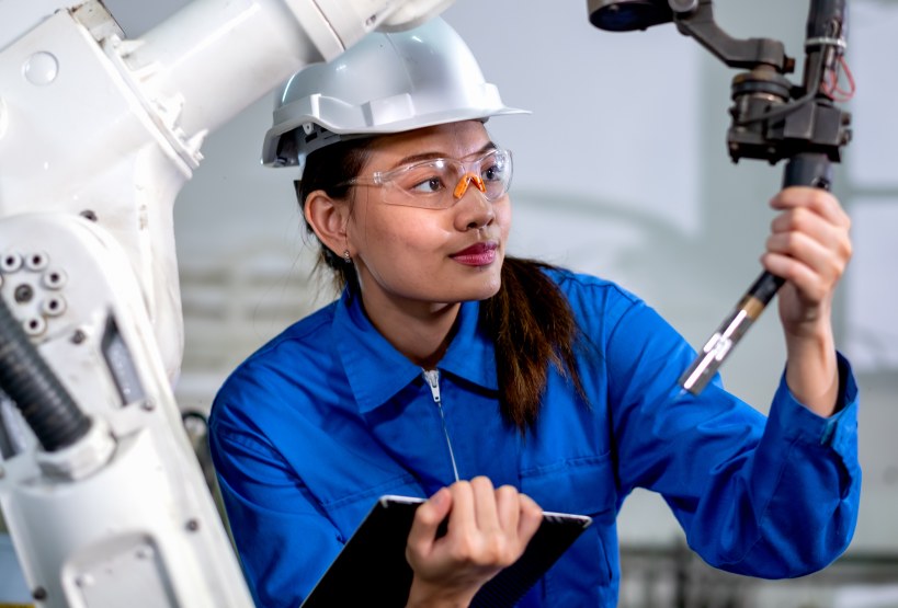 Female Factory Worker Predictive Maintenance Robotics Manufacturing