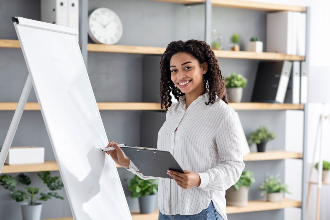 A productivity coach writing on a white piece of paper