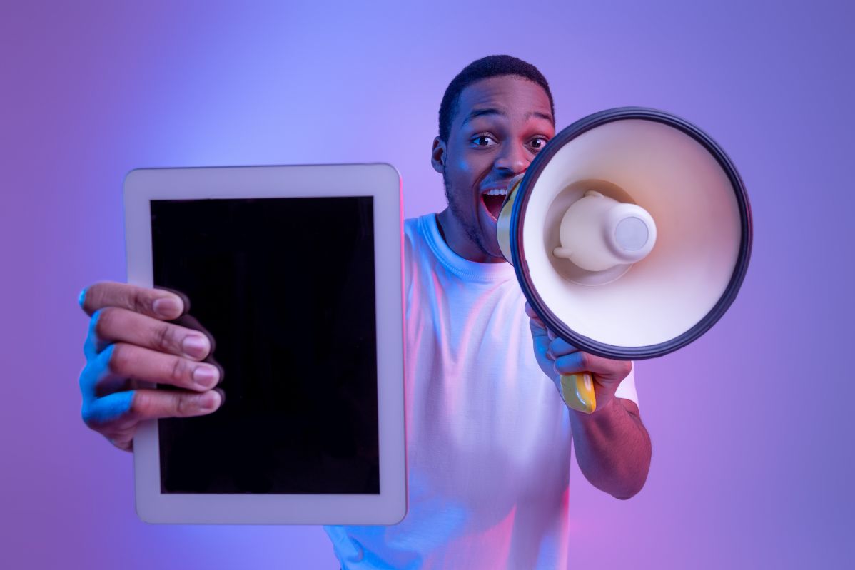 Man With Loudspeaker Holding Digital Tablet