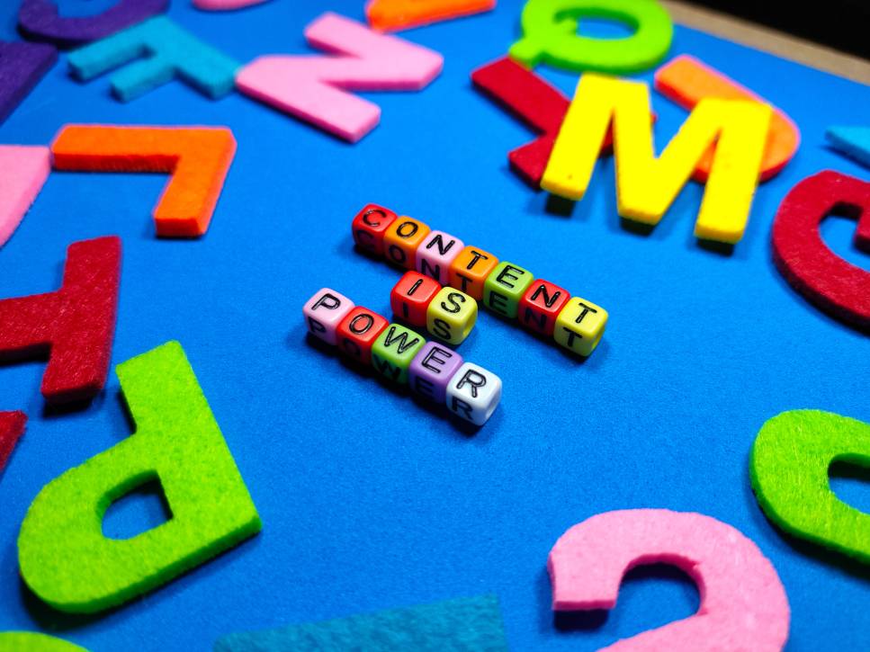 Colorful dice with word CONTENT IS POWER