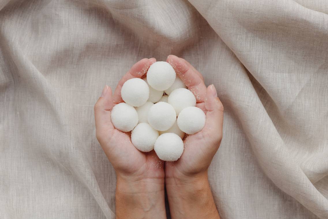 Female hands holding solid handmade natural shampoo or sugar scrub balls. Capturing the ideal market for business.