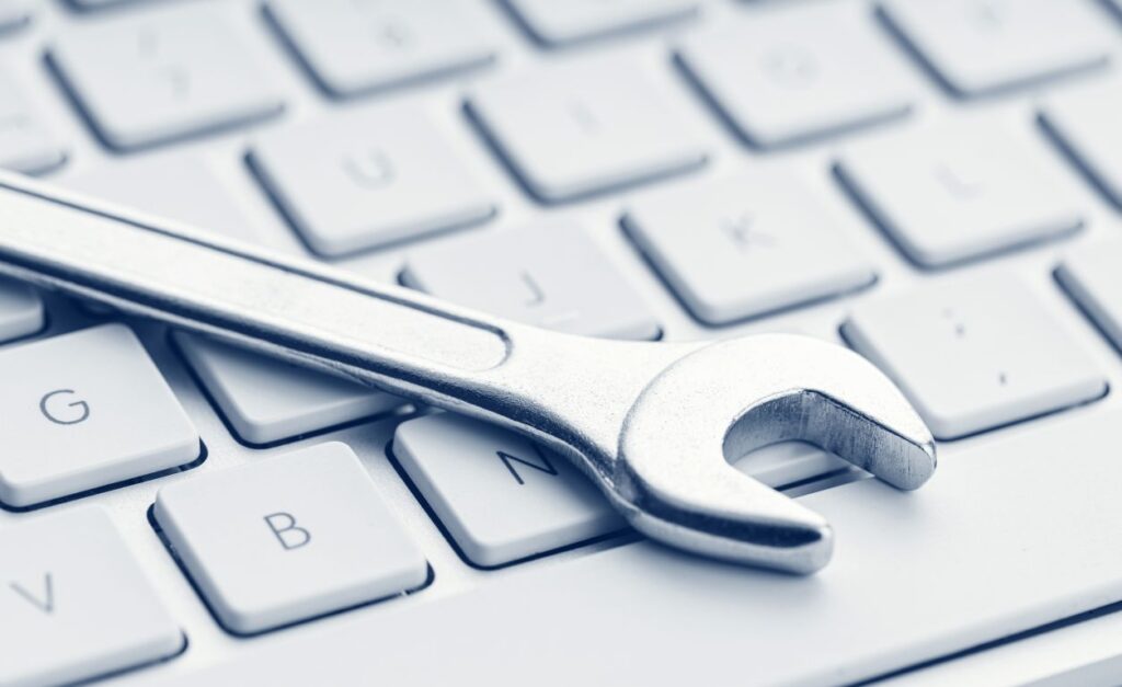 Wrench on computer keyboard. Online tools can help you identify the ideal market for your business.