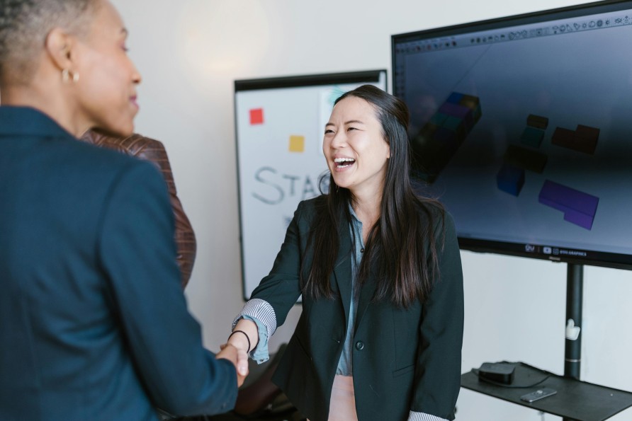 External Cash Sources Funding Woman Smiling Shaking Hands