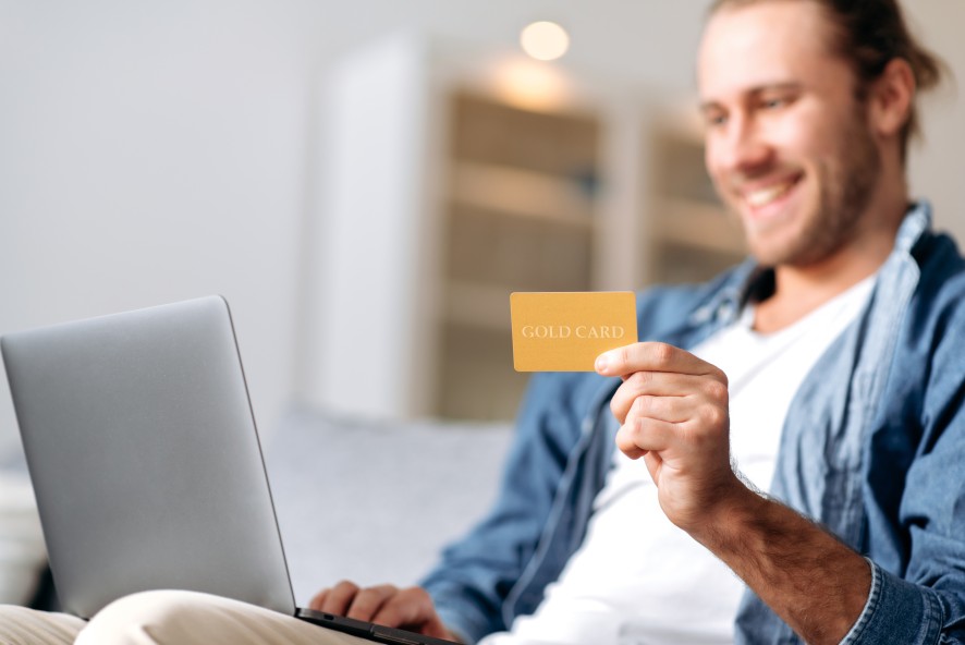 Online Customer Loyalty Program Man Holding Gold Card