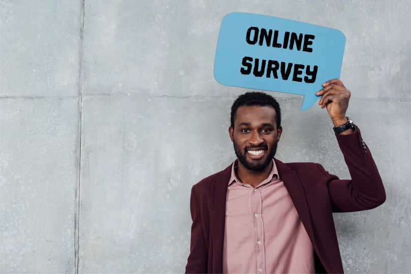 Online Survey Concept Male Handling Bubble Speech Over the Head