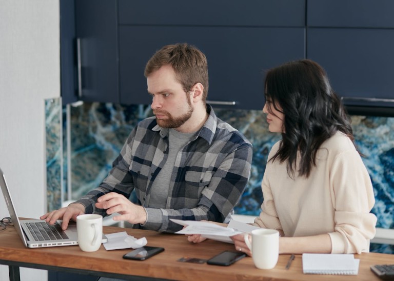 A man and woman working on laptop