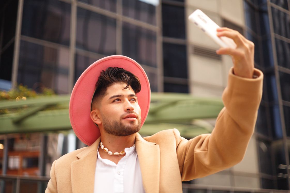 Man taking selfie in modern outdoors for his TikTok Shop Creator account